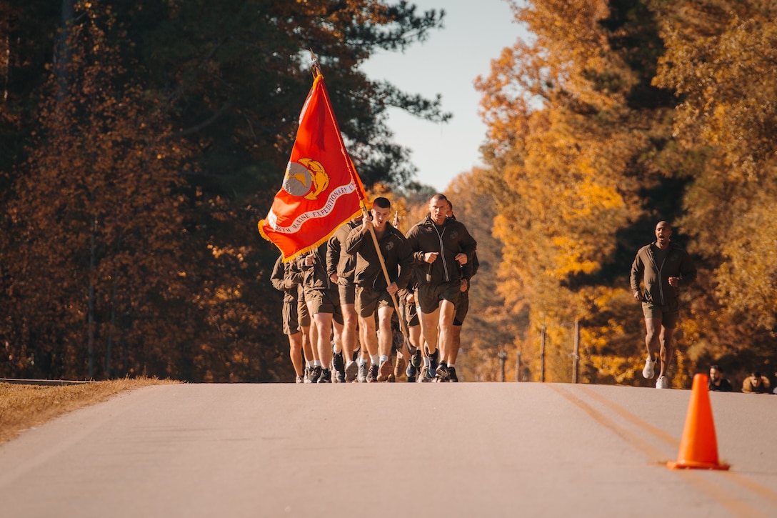A group of U.S. Marines with the 26th Marine Expeditionary Unit run the final miles of the colors run on Fort Pickett, Virginia, Nov. 10, 2021. In honor of 246 years of faithful service, Marines and Sailors with the 26th Marine Expeditionary Unit carried the U.S. Marine Corps colors 246 miles over the course of 41 hours, from Nov. 8 to Nov. 10, 2021. (U.S. Marine Corps photo by Lance Cpl. Zachary Zephir)