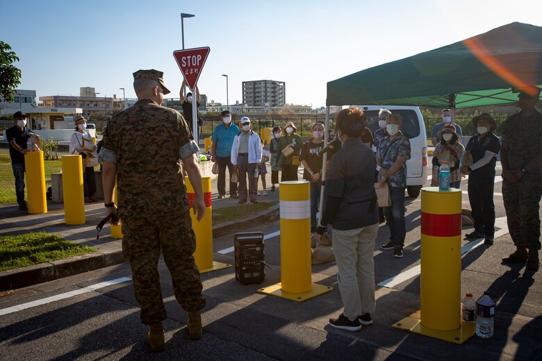 U.S. Marine Corps Col. Jeffrey L. Hammond, camp commander of Camps Foster and Lester and commanding officer of Headquarters and Support Battalion, Marine Corps Installations Pacific, talks to the local community residents and Marines who participated in the tsunami evacuation drill on Camp Foster, Okinawa, Japan, Nov. 3, 2021. The drill was held to convey the readiness and capabilities of the camp to service members and local communities in the event of an emergency. (U.S. Marine Corps photo by Cpl. Karis Mattingly)