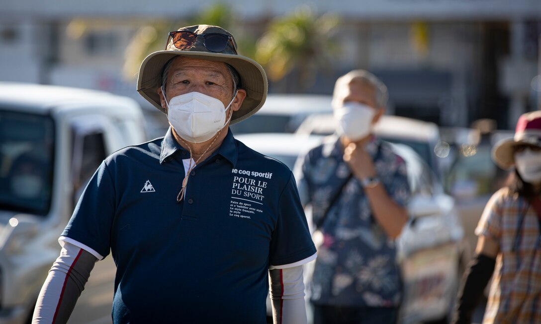 Local community residents walk into Gate 5 to participate in a tsunami evacuation drill on Camp Foster, Okinawa, Japan, Nov. 3, 2021. The drill was held to convey the readiness and capabilities of the camp to U.S. service members and local communities in the event of an emergency. (U.S. Marine Corps photo by Cpl. Karis Mattingly)