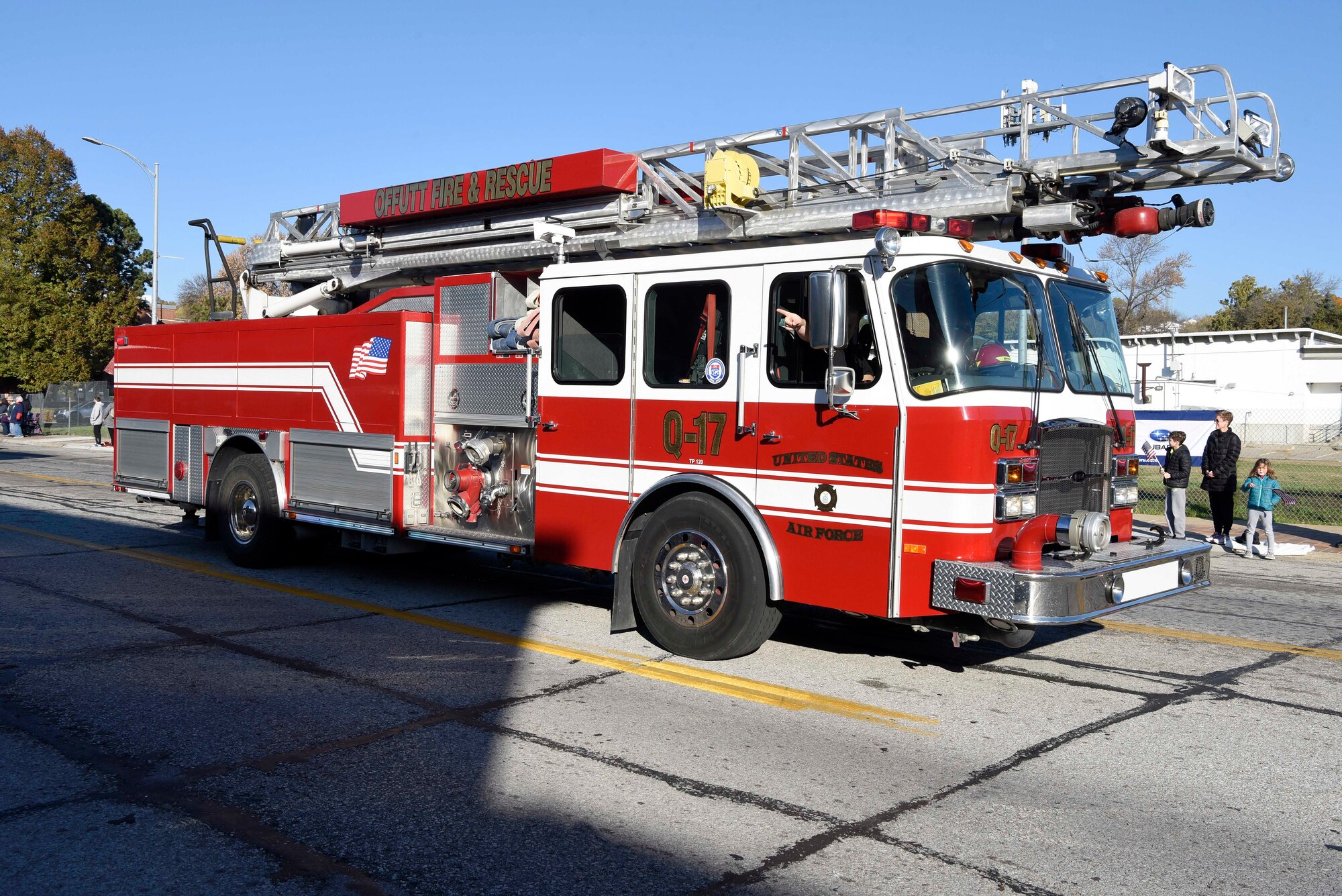 A fire truck drives down the middle of the street
