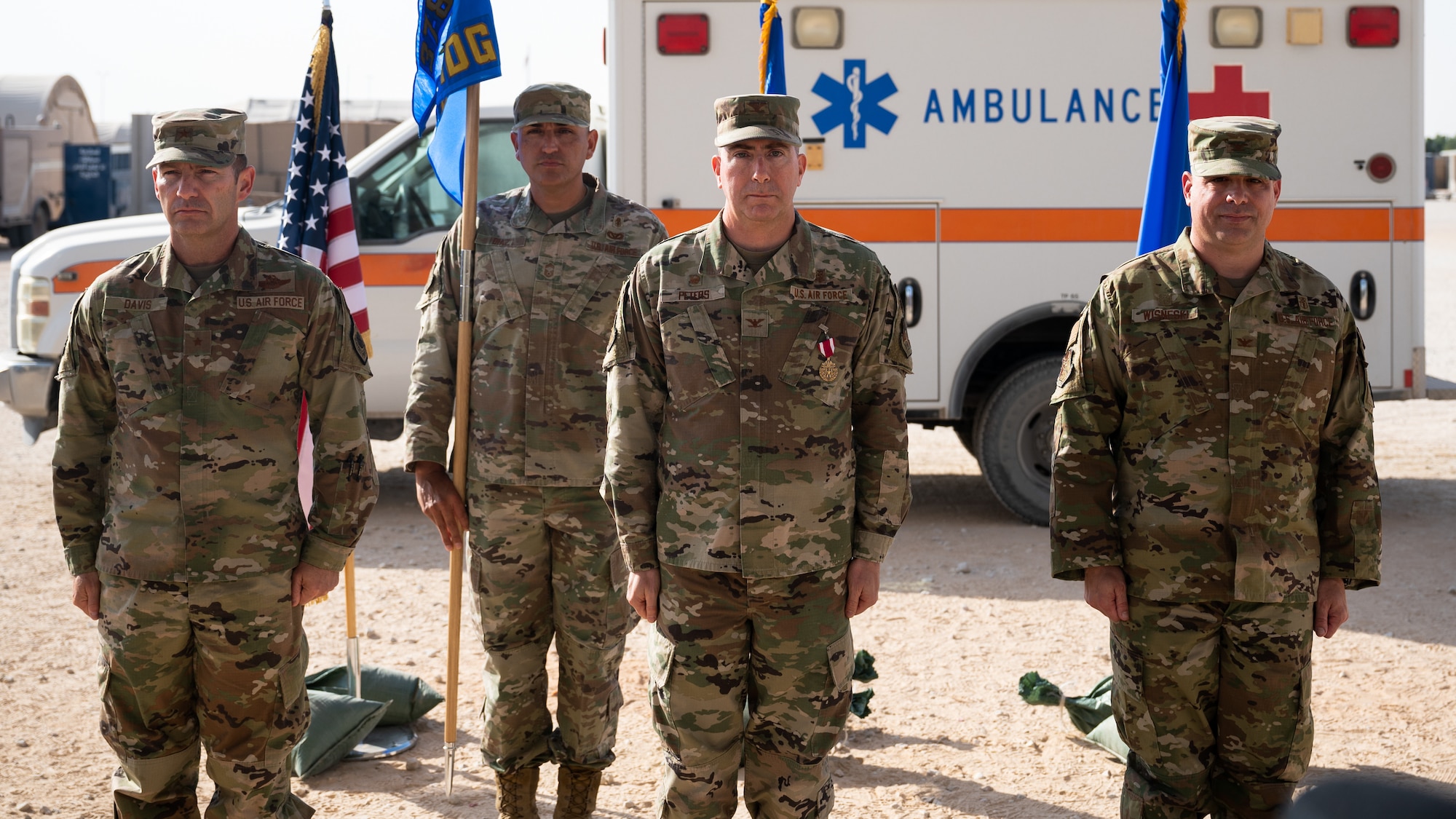 Brig. Gen. Robert Davis, 378th Air Expeditionary Wing commander, Col. Wayne Peters, outgoing 378th Expeditionary Medical Group commander, and Col. Jeffrey Wisneski, incoming 378th EMDG commander, stand at the [position of attention during the 378th EMDG change of command ceremony at Prince Sultan Air Base, Kingdom of Saudi Arabia, Nov. 9, 2021. A change of command is a military tradition that represents a formal transfer of authority and responsibility for a unit from one commanding officer to another. (U.S. Air Force photo by Senior Airman Jacob B. Wrightsman)