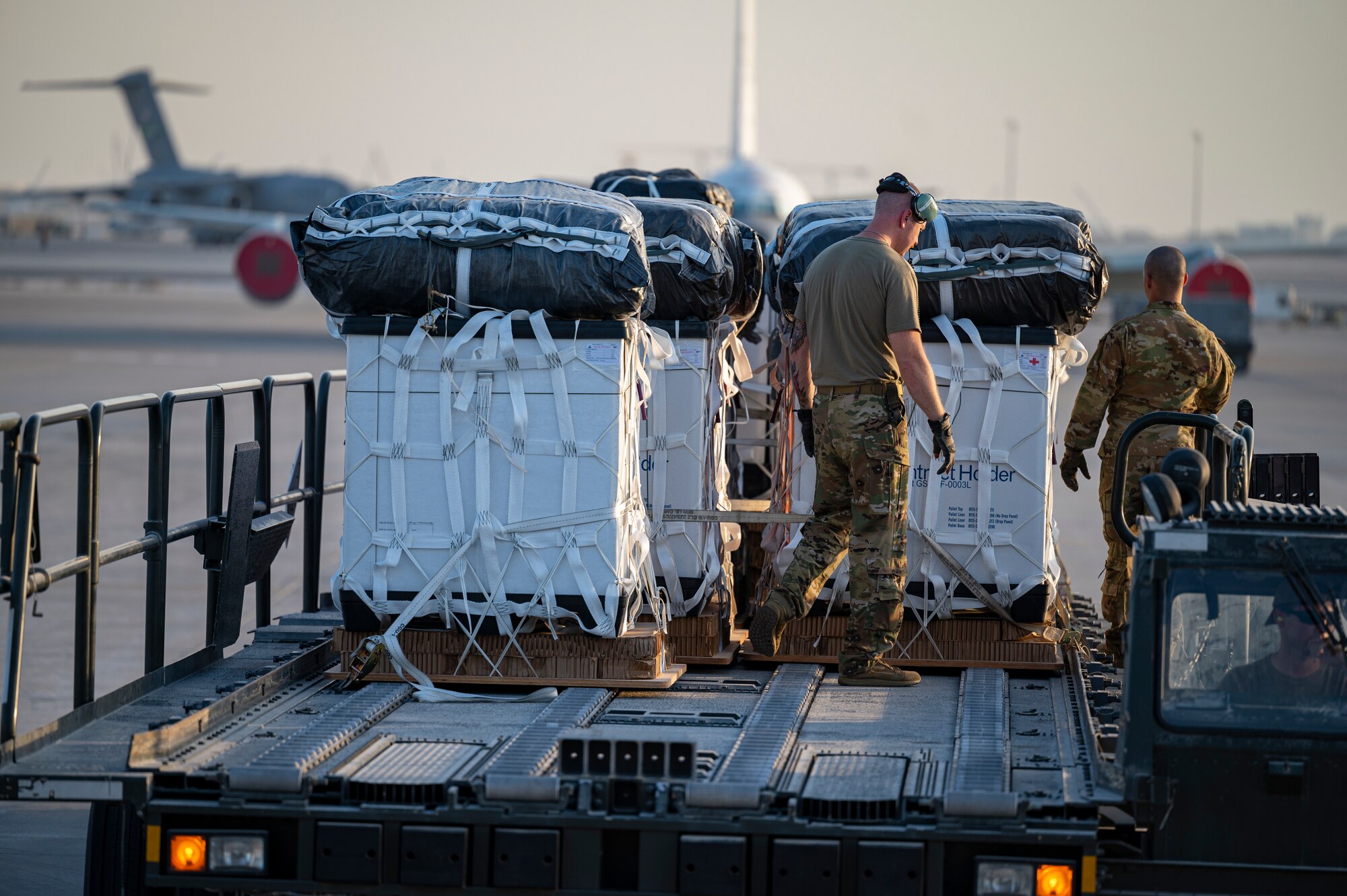 Loadmasters assigned to the 779th Expeditionary Airlift Squadron inspect cargo to be air-dropped from a C-130H Hercules before loading at Al Udeid Air Base, Qatar, Oct. 31, 2021.