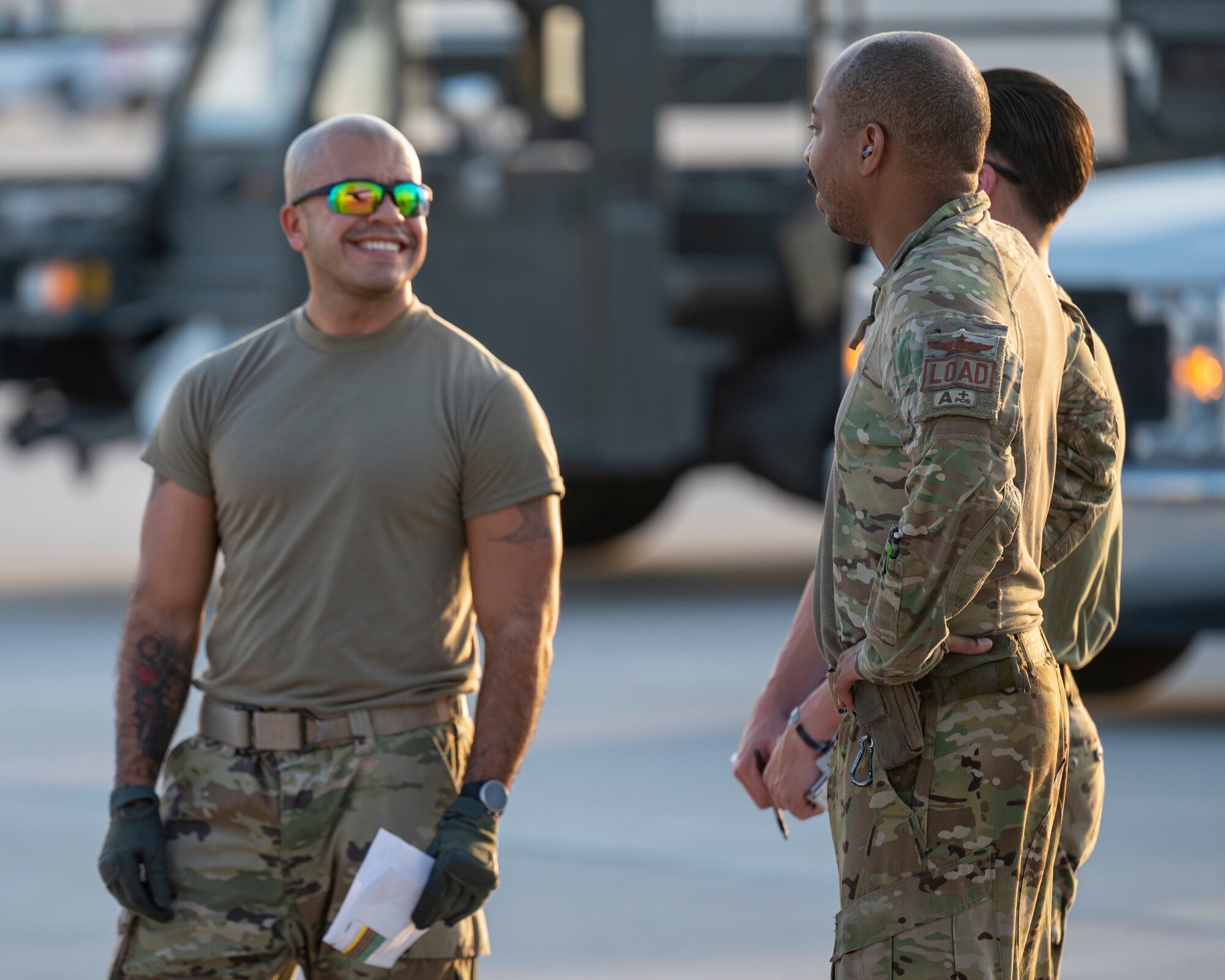 Members assigned to the 779th Expeditionary Airlift Squadron and 8th Expeditionary Air Mobility Squadron discuss cargo loading to a C-130H Hercules at Al Udeid Air Base, Qatar, Oct. 31, 2021.