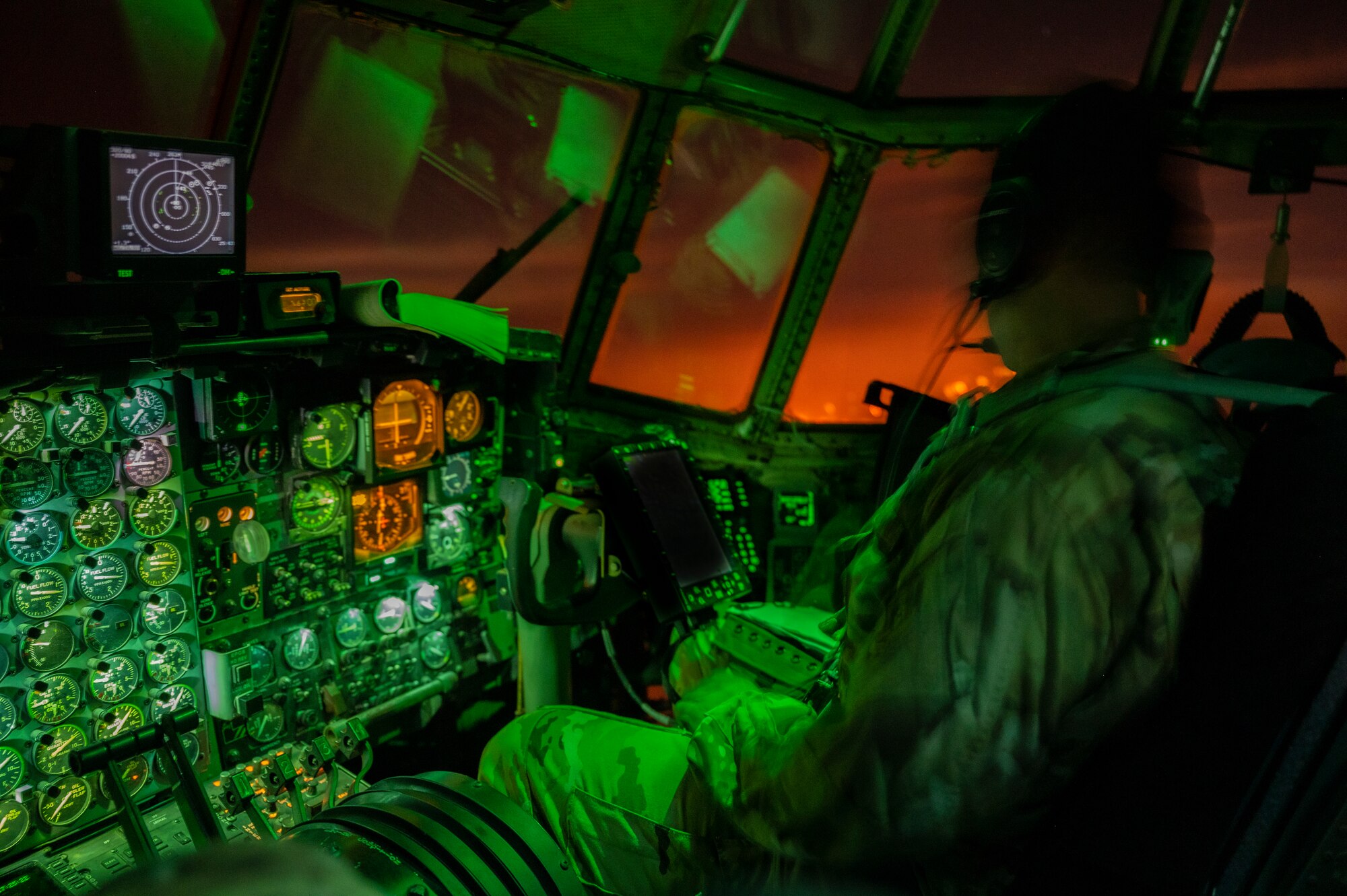 A copilot assigned to the 779th Expeditionary Airlift Squadron conduct flight operations on a C-130H Hercules above an undisclosed location in Southwest Asia, Oct. 31, 2021.