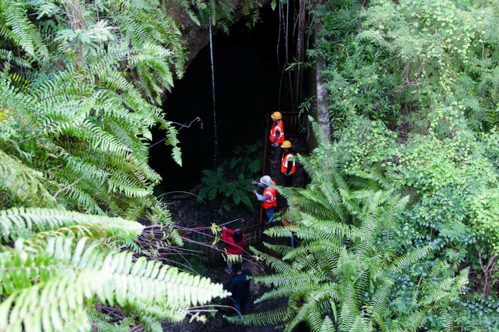University of Guam faculty and graduate students study a sinkhole and karst terrain at Tarague Well 4 at Andersen Air Force Base Oct. 8. Navy environmental specialists escorted John Jensen, University of Guam chief hydrogeologist and professor of environmental geology, and Water & Environmental Research Institute Western Pacific director, and his graduate students to the area to study the unique karst at the Air Force Base.