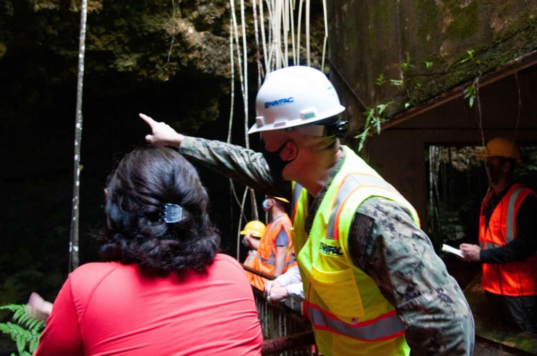 Cmdr. Brian Christner, Marine Corps Base Camp Blaz public works officer, discusses features of a sinkhole and karst terrain with a University of Guam graduate student during a tour of Tarague Well 4 at Andersen Air Force Base Oct. 8. Navy environmental specialists escorted John Jensen, University of Guam chief hydrogeologist and professor of environmental geology, and Water & Environmental Research Institute Western Pacific director, and his graduate students to the area to study sinkholes and karst terrain at the Air Force Base.