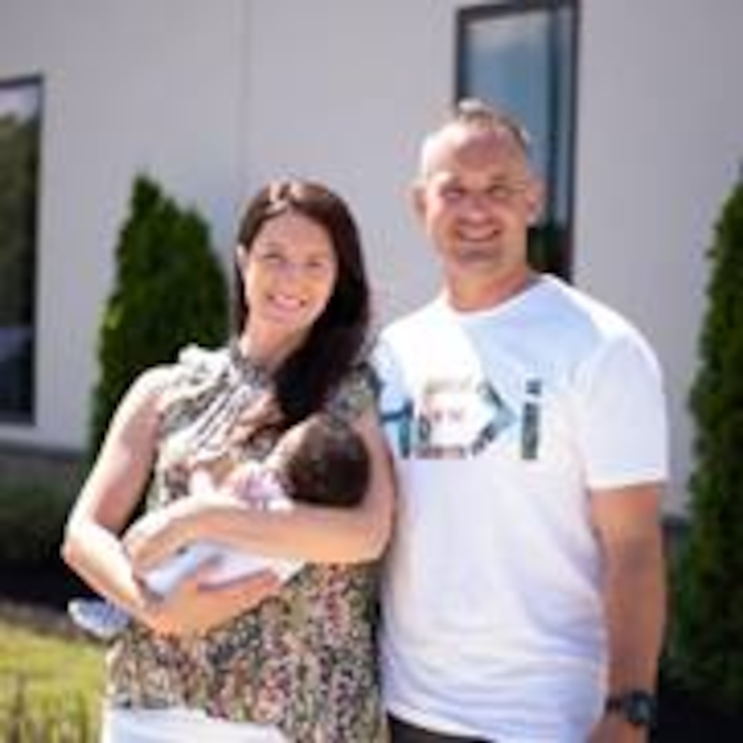 Chief Petty Officer Adam Season (Officer-in-charge of Aids to Navigation Team Chincoteague) (right) and his wife, Joanna (left), with their son, Isaac, whom they adopted in 2020.