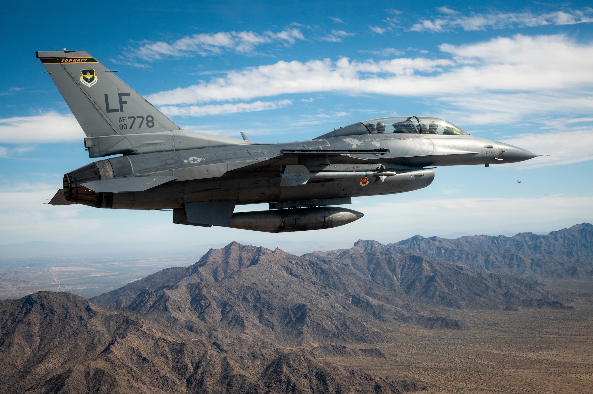 A U.S. Air Force F-16 Fighting Falcon assigned to the 56th Fighter Wing, Luke Air Force Base, Arizona, flies over Phoenix during the NASCAR Cup Series Championship Nov. 7, 2021.