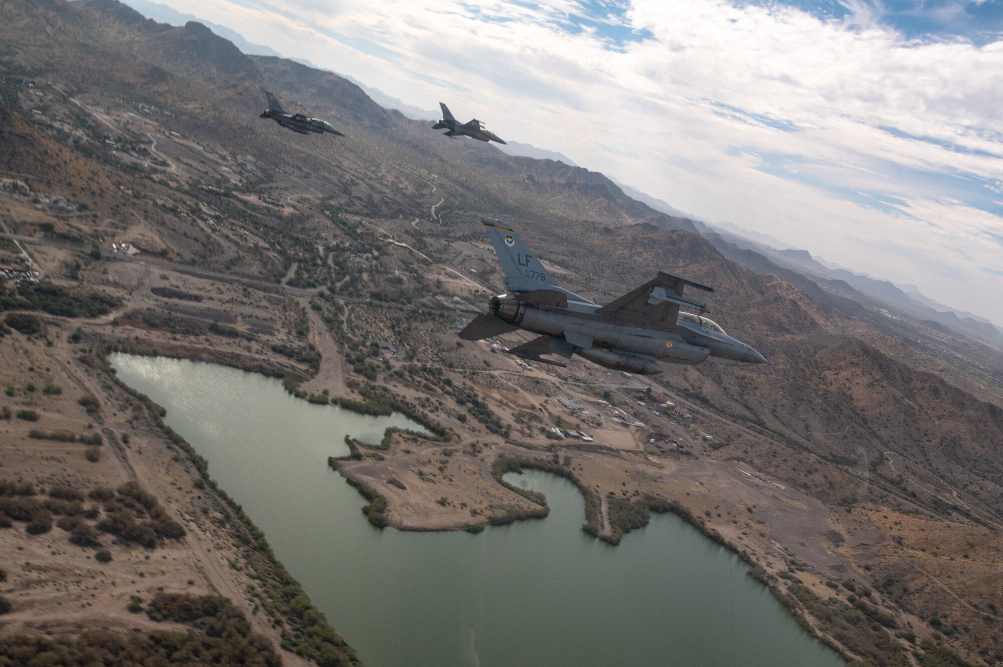 Three U.S. Air Force F-16 Fighting Falcons assigned to the 56th Fighter Wing, Luke Air Force Base, Arizona, fly over Phoenix during the NASCAR Cup Series Championship Nov. 7, 2021.