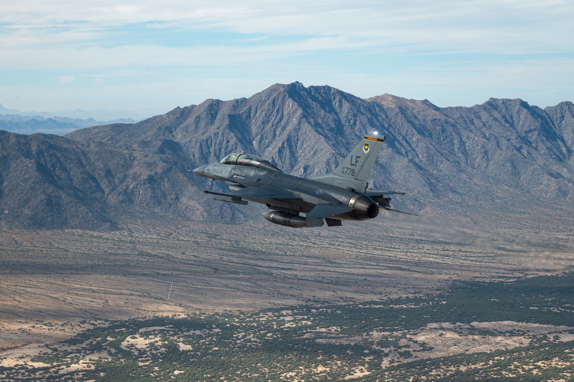 A U.S. Air Force F-16 Fighting Falcon assigned to the 56th Fighter Wing, Luke Air Force Base, Arizona, flies over Phoenix during the NASCAR Cup Series Championship Nov. 7, 2021.