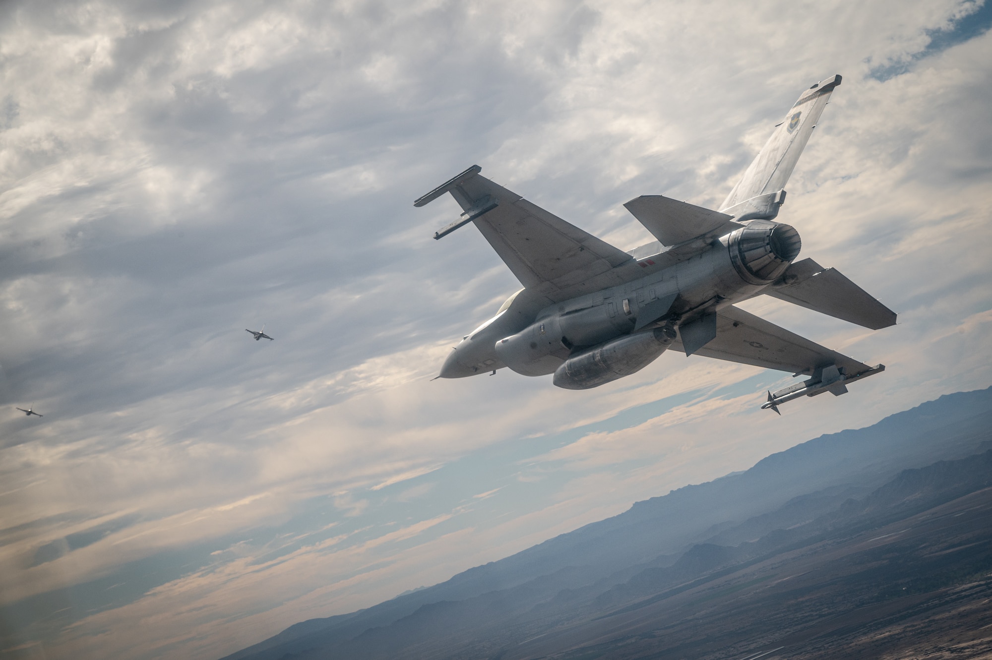 A U.S. Air Force F-16 Fighting Falcon assigned to the 56th Fighter Wing, Luke Air Force Base, Arizona, flies over Phoenix during the NASCAR Cup Series Championship Nov. 7, 2021.