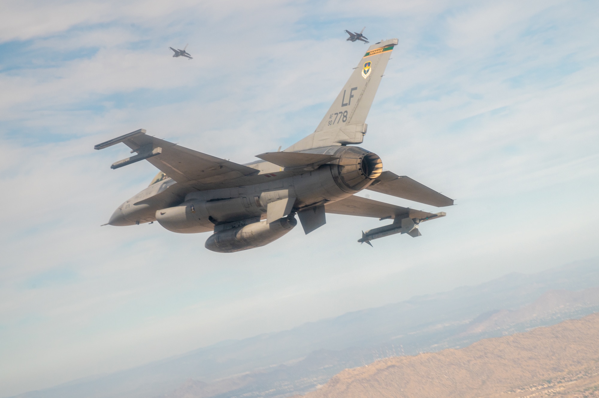 Three U.S. Air Force F-16 Fighting Falcons assigned to the 56th Fighter Wing, Luke Air Force Base, Arizona, fly over Phoenix during the NASCAR Cup Series Championship Nov. 7, 2021.