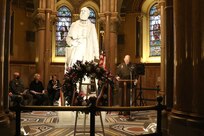 Brigadier Gen. Christopher Dziubek, commanding general, 351st Civil Affairs Command, reads a speech honoring President James A. Garfield, during the wreath laying ceremony honoring the 20th President of the United States November 13, 2021, in Cleveland, Ohio. Each year, near the date of Garfield's birth, Lake View Cemetery hosts a ceremony honoring the life and legacy of the man who served as president from March to September 1881.