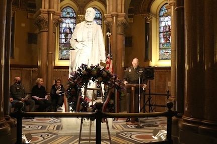 Brigadier Gen. Christopher Dziubek, commanding general, 351st Civil Affairs Command, reads a speech honoring President James A. Garfield, during the wreath laying ceremony honoring the 20th President of the United States November 13, 2021, in Cleveland, Ohio. Each year, near the date of Garfield's birth, Lake View Cemetery hosts a ceremony honoring the life and legacy of the man who served as president from March to September 1881.