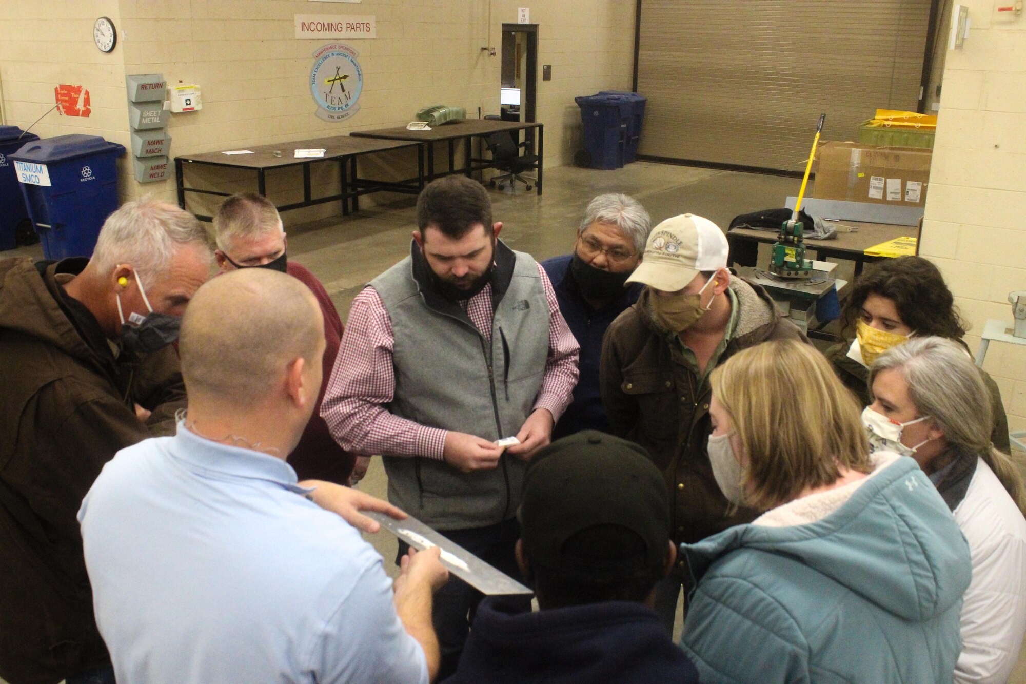 Man shows riveted metal to others