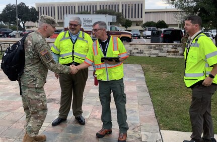 Maj. Gen. Dennis LeMaster (far left), U.S. Army Medical Center of Excellence commanding general, thanks the Air Force Civil Engineer Center drone pilots.