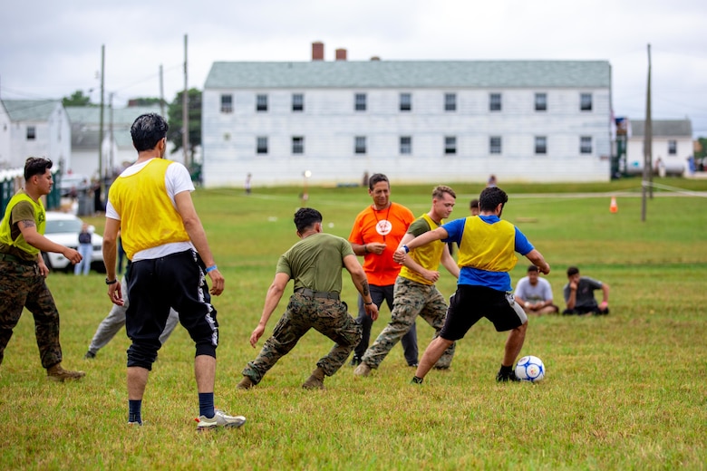 U.S. Marines with 3rd Battalion, 6th Marine Regiment play soccer with Afghan civilians during a soccer camp hosted by the Charlotte Eagles in support of Operation Allies Welcome in Fort Pickett, Virginia, Sept. 17, 2021.