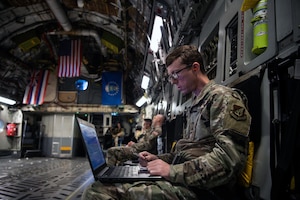 Tech. Sgt. Carl Williams, 747th Cyberspace Squadron standards and evaluations craftsman, observes radio frequencies recorded by a stand-alone hub activity reconnaissance kit while aboard a C-17 Globemaster III near the Hawaiian Islands, Nov. 3, 2021. A Mission Defense Team from the 747th CS and Airmen from the 535th Airlift Squadron worked together to defend the C-17 from cyber attacks by preventing adversaries from invading the airspace and manipulating aircraft data.