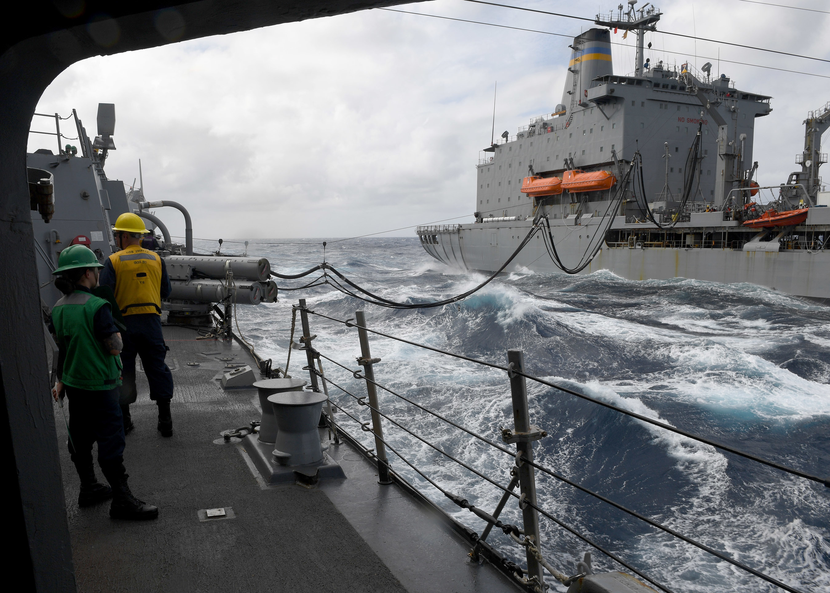 Sailors aboard Arleigh Burke-class guided-missile destroyer USS Chafee (DDG 90) stand watch as they conduct a replenishment-at-sea with Henry J. Kaiser-class fleet replenishment oiler USNS John Ericsson (T-AO 194), Nov. 9, 2021.