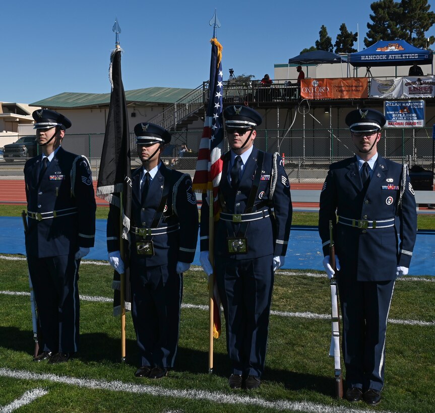 Vandenberg Space Force Base Honor Guard presents the colors at Allan Hancock Stadium Nov. 13, 2021, in Santa Maria, Calif. The Honor Guard presented the colors for the start of the military appreciation game between the Allan Hancock College Bulldogs and the Bakersfield College Renegades. (U.S. Space Force photo by Airman First Class Tiarra Sibley)