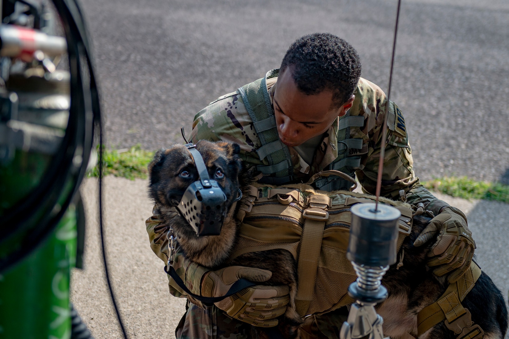U.S. Army Sgt. Nayveon Wheaton, a military working dog (MWD) handler assigned to U.S. Army South, Joint Task Force Bravo, comforts his MWD Eris before conducting hoist familiarization on an UH-60 Blackhawk at Soto Cano Air Base, Honduras, Oct. 29, 2021.