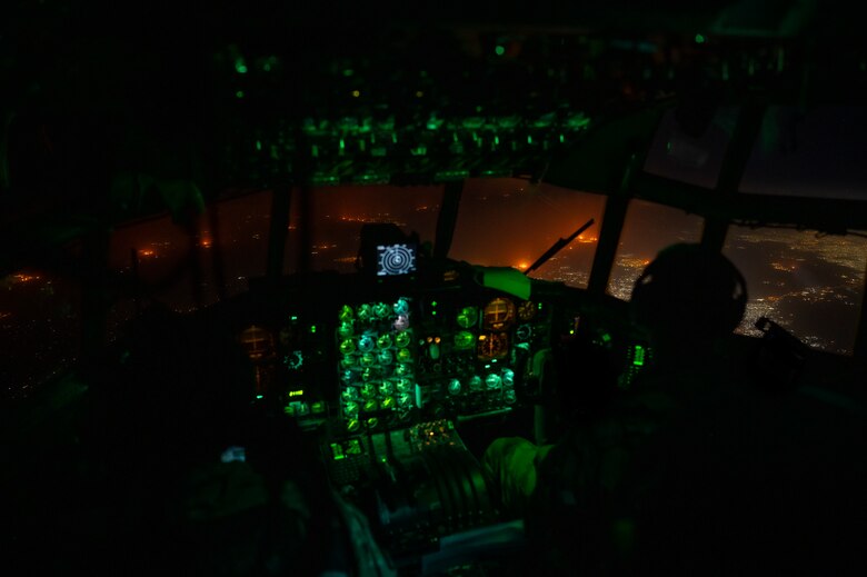 Crew members assigned to the 779th Expeditionary Airlift Squadron conduct flight operations on a C-130H Hercules above an undisclosed location in Southwest Asia, Oct. 31, 2021.