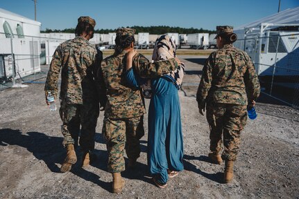 U.S. Marines assigned to the Female Engagement Team with 3rd Battalion, 6th Marine Regiment, walk with an Afghan individual on Fort Pickett, Virginia, Sept. 24, 2021.