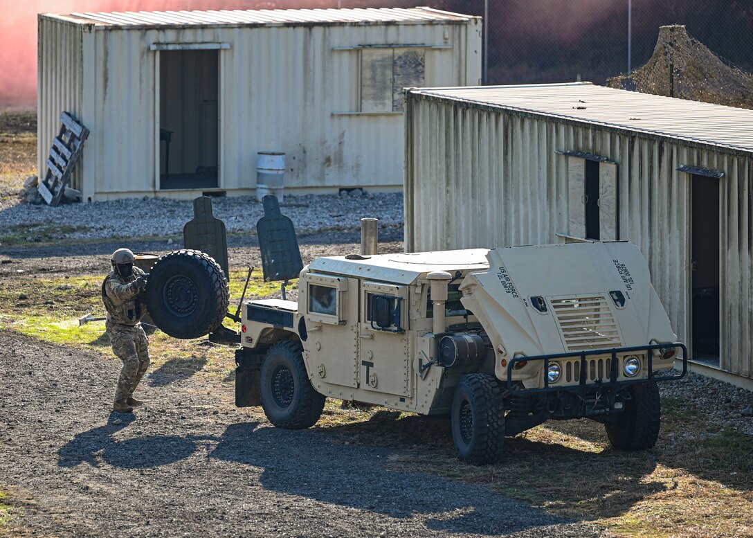 An Airman fires simunition rounds during a training exercise