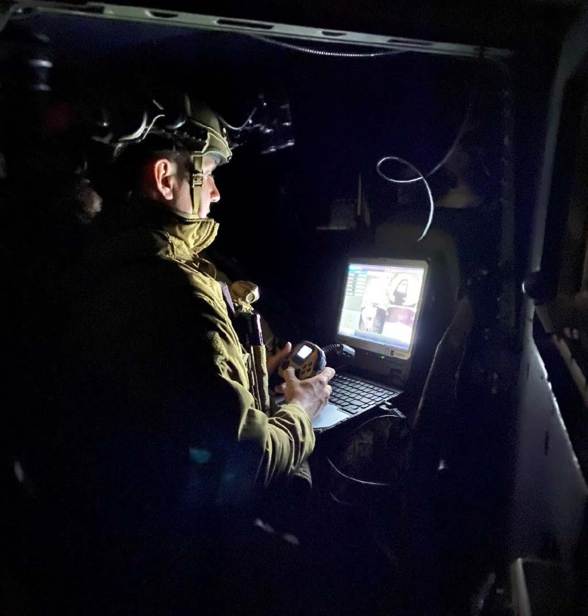 An Airman controls a robot