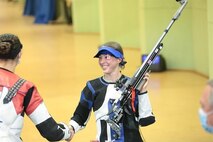 Female competitors shaking hands.