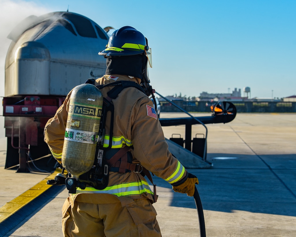 A firefighter assigned to the 45th Civil Engineer Squadron at Patrick Space Force Base, Fla., battles a simulated aircraft fire at Patrick SFB Nov. 3, 2021. Simulated aircraft fires are held annually to help firefighters maintain certifications and prepare for emergency situations. (U.S. Space Force photo by Airman 1st Class Dakota Raub)
