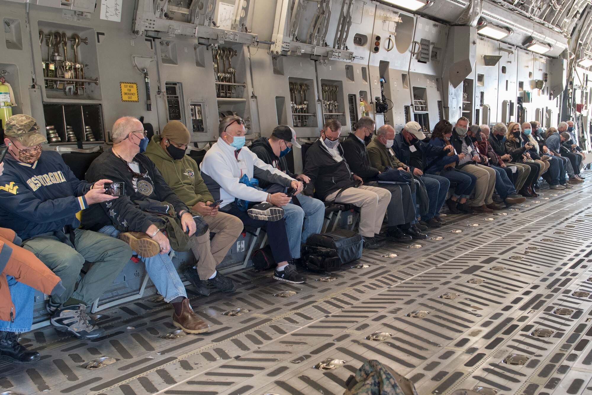 Employers participating in the Employer Support of the Guard and Reserve Bosslift event at the 167th Airlift Wing, Nov. 9, 2021, wait for take-off on a C-17 Globemaster III aircraft. Participants toured the Martinsburg, West Virginia air base and learned about the mission of the unit as well as the ESGR during the event. (U.S. Air National Guard photo by Senior Master Sgt. Emily Beightol-Deyerle)