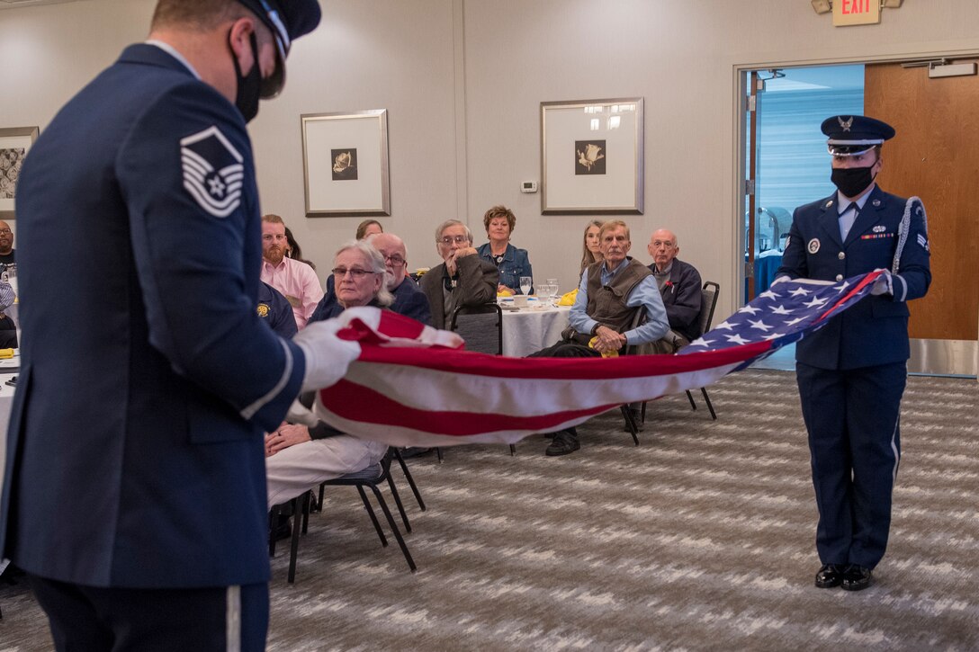 167th Airlift Wing Base Honor Guard members, Master Sgt. Justin Byrd and Senior Airman Caley Ardnt, perform a flag folding for the Rotary Club of Martinsburg, for the Rotary’s Veteran’s Day luncheon at the Holiday Inn in Martinsburg, West Virginia, Nov. 11, 2021. The honor guard participated in several Veteran’s Day events throughout the week. (U.S. Air National Guard photo by Senior Master Sgt. Emily Beightol-Deyerle)