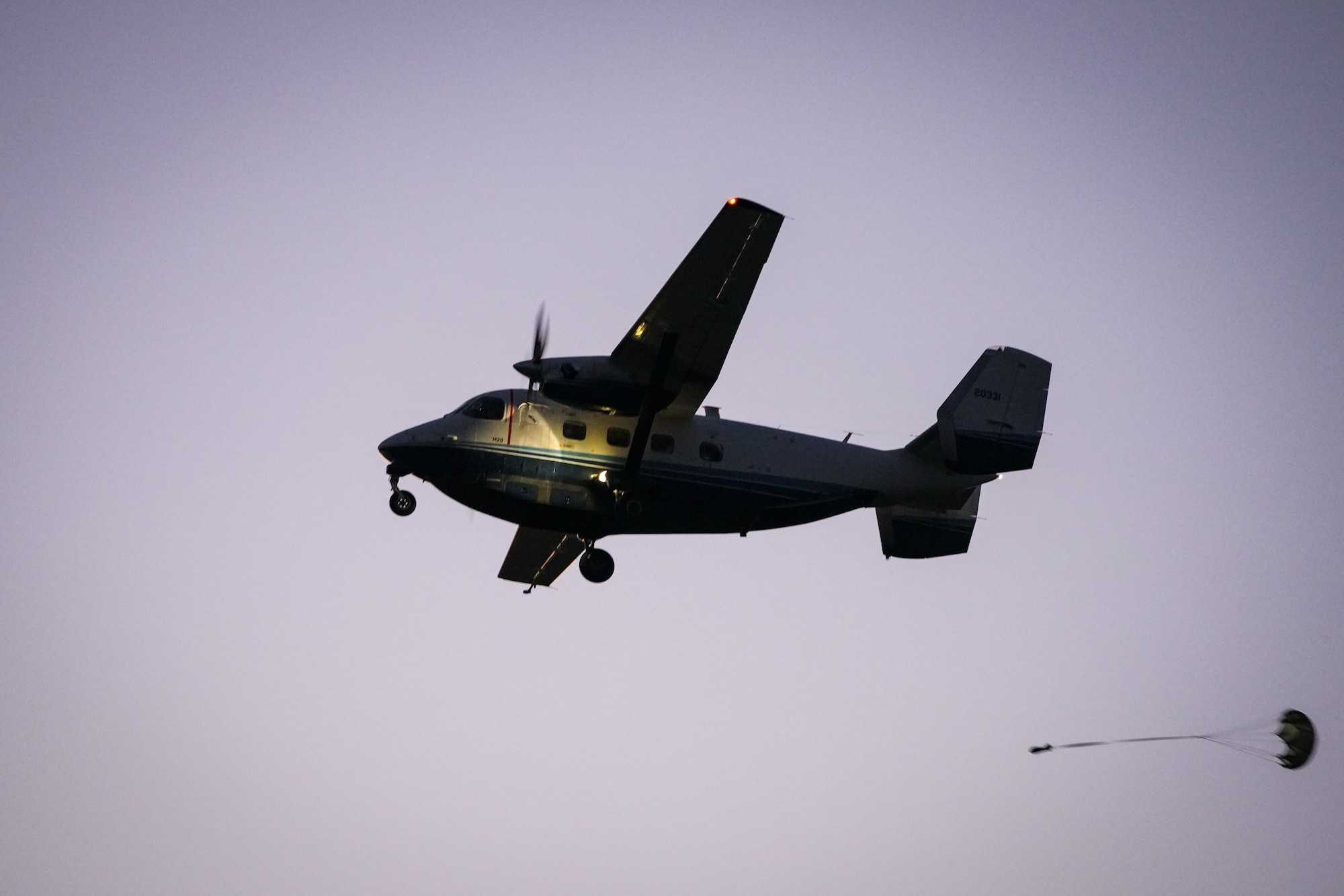 A C-145A aircraft drops a sand bag during a night-time training exercise outside of Mossy Head, Florida, April 1, 2021. The C-145A’s primary role is to ensure proficiency of  Combat Aviation Advisors to conduct Aviation Foreign Internal Defense missions to strengthen partner nation capacity around the globe. (U.S. Air Force photo by Senior Airman Dylan Gentile)