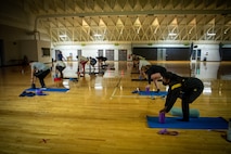 people kneeling on yoga mats.