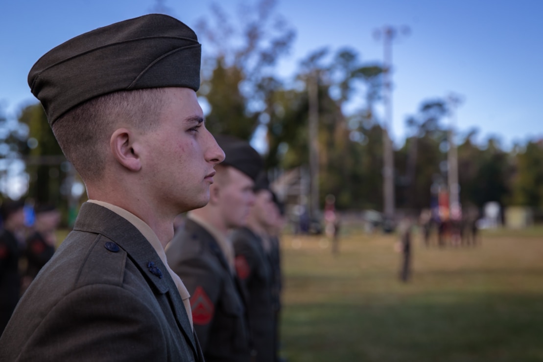 U.S. Marines with 6th Marine Regiment, 2d Marine Division, stand at parade rest during a Veterans Day Ceremony on Camp Lejeune, N.C., Nov. 10, 2021. Veterans Day is a celebration to honor all past and present members of the armed forces. (U.S. Marine Corps photo by Lance Cpl. Emma Gray)