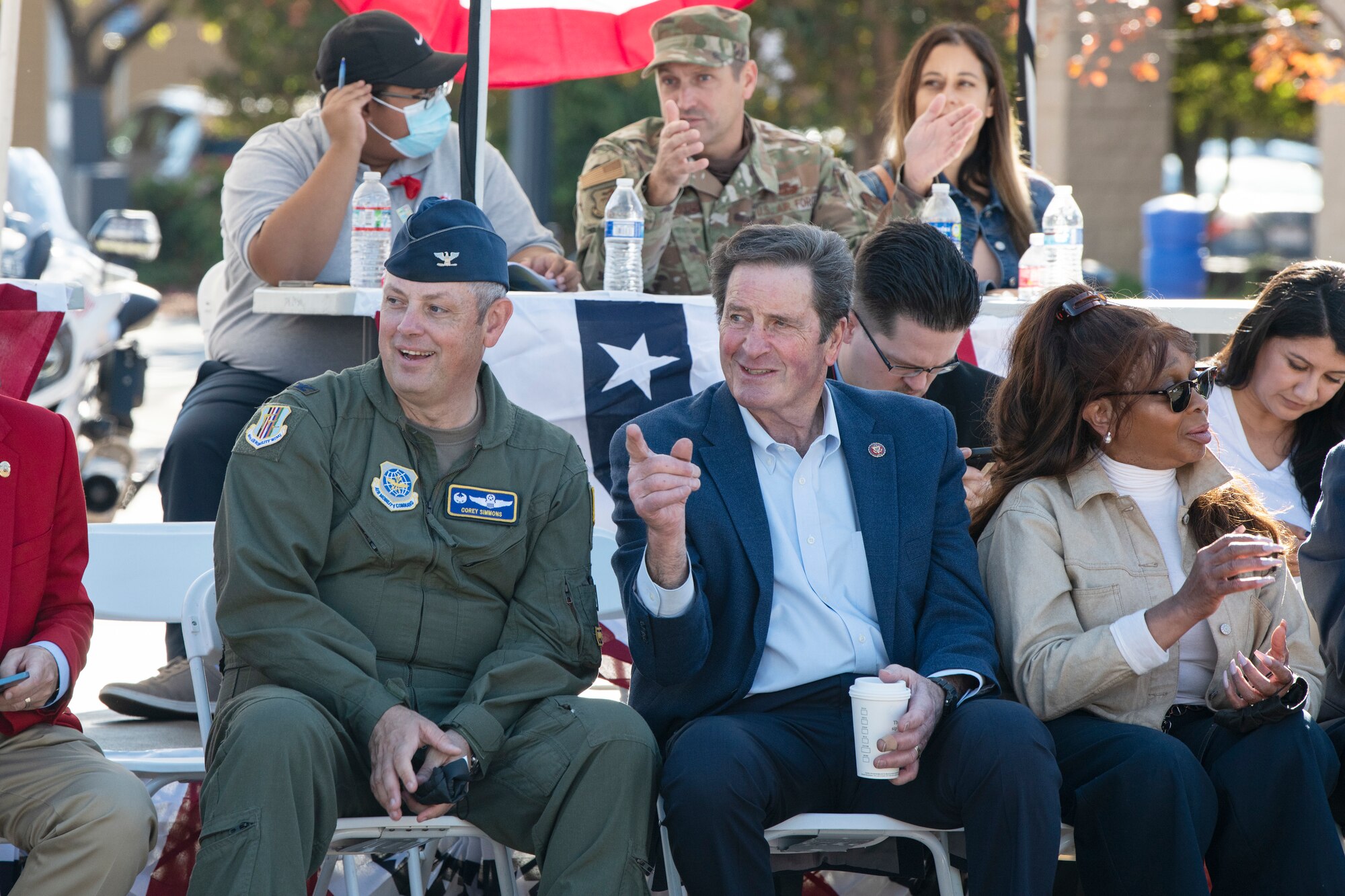 Col. Corey Simmons, 60th Air Mobility Wing commander and Congressman John Garamendi enjoy the passing floats at Fairfield Veterans Day Parade, Nov. 11, 2021. Airmen from Travis Air Force Base, California were among the many featured at this year's parade. (U.S. Air Force photo by Grant Okubo)