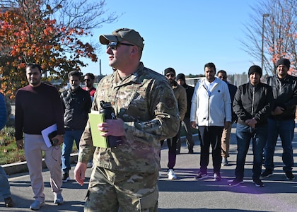 Maj. Aaron McCarthy, NHNG Counterdrug Program coordinator, leads a delegation from the General Directorate of Narcotics Control, Kingdom of Saudi Arabia, on a tour of the Army Aviation Support Facility on Nov. 3 in Concord.