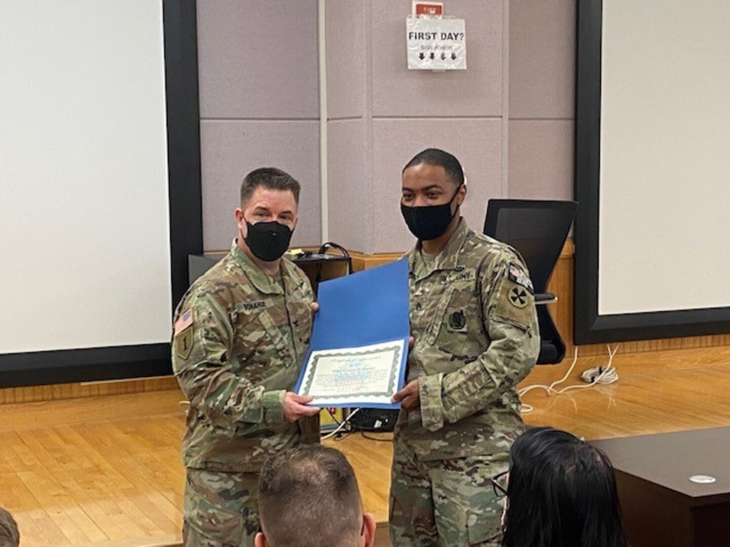 Army Staff Sgt. Corey Jennings, 19th Expeditionary Sustainment Command, 19th Human Resources Company, poses with DLA Indo-Pacific Military Deputy Commander Army Col. Brian Donahue, after receiving a certificate of appreciation for his work with the U.S. Army Garrison Humphreys’ COVID-19 Reception Center, South Korea, November 5, 2021. The reception team was recognized for their work processing the arrival of thousands of military members, DoD employees and family members per week while adhering to and implementing COVID-19 protocols.