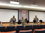 DLA Indo-Pacific Military Deputy Commander Army Col. Brian Donahue speaks with members of the Army’s 19th Human Resources Company COVID-19 Reception Center on U.S. Army Garrison Humphreys, South Korea, November 5, 2021. The reception team was recognized for their work processing the arrival of thousands of military members, DoD employees and family members per week while adhering to and implementing COVID-19 protocols.