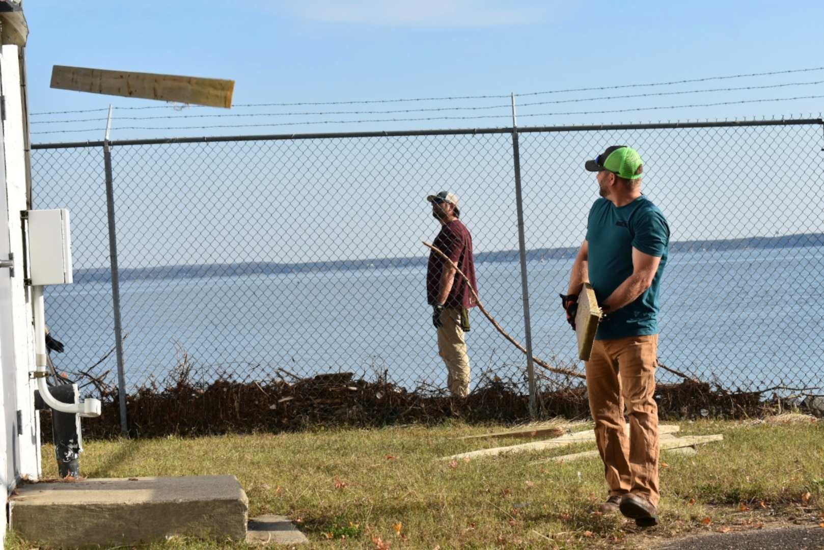 IMAGE: Members of the Potomac River Test Range (PRTR) maintenance crew clean up debris around PRTR Range Station Seven in Colonial Beach, Nov. 10.