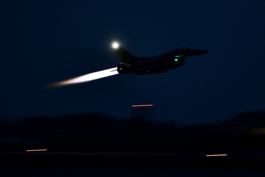 An aircraft takes off in the dark.