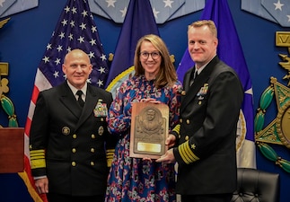 WASHINGTON (Nov. 16, 2021) Chief of Naval Operations (CNO) Adm. Mike Gilday, left, presents the Vice Adm. James Bond Stockdale Leadership Award to Capt. William H. Wiley, right, the Special Assistant for Fleet Matters, Naval Reactors Line Locker, and his wife during a ceremony in the Pentagon. Capt. Wiley and Capt. Bradley D. Geary, commanding officer of Naval Special Warfare Basic Training Command, received the award, which is peer-nominated and presented annually to two commissioned officers who serve as examples of excellence in leadership. (U.S. Navy photo by Mass Communication Specialist 1st Class Sean Castellano/Released)
