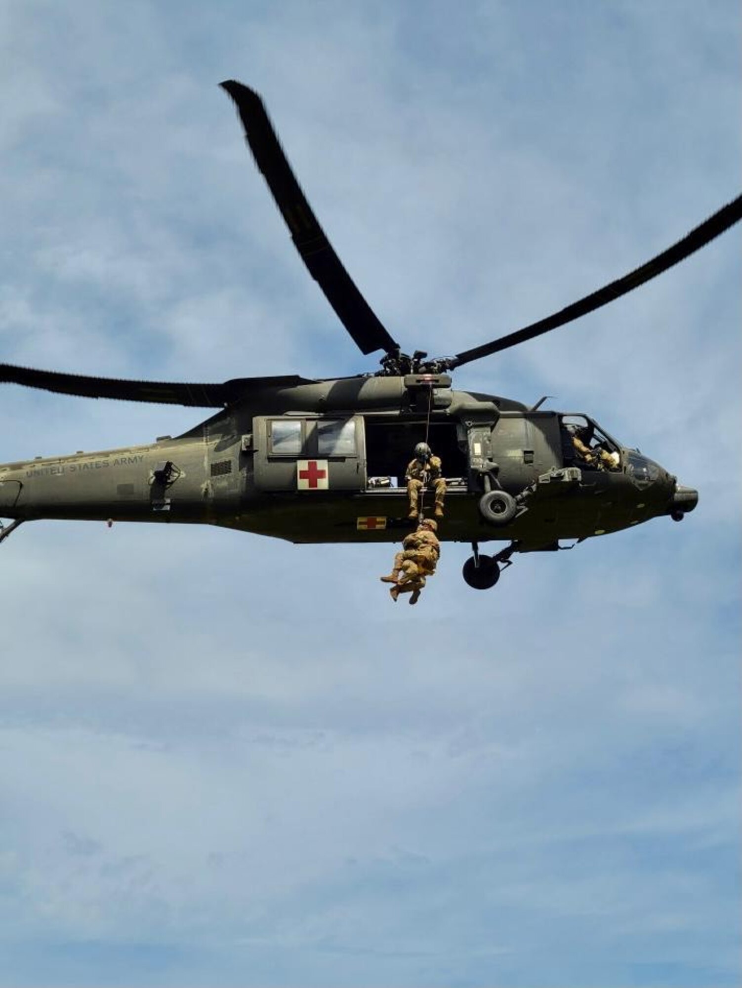 NCO is lifted into helicopter