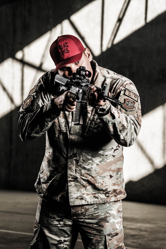 Staff Sgt. Jose Bracero-Camareno, 436th Security Forces Squadron combat arms instructor, takes aim through the sights of an M4 carbine Nov. 8, 2021, at Dover Air Force Base, Delaware. Each year approximately 1,700 personnel receive training and qualification at the Dover AFB Combat Arms Training and Maintenance facility. (U.S. Air Force photo by Mauricio Campino)