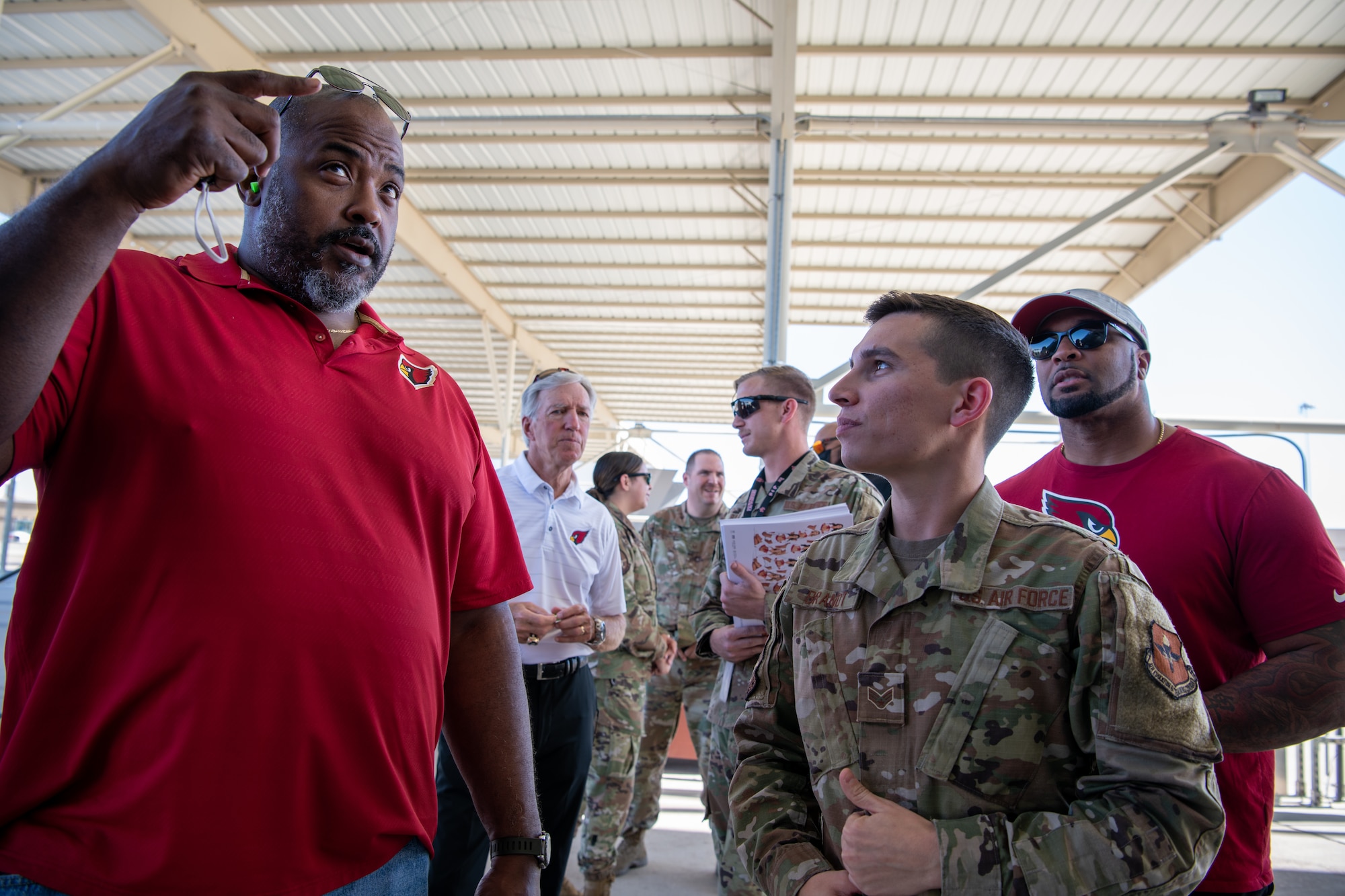Arizona Cardinals alumni meet with Airmen from the 61st Aircraft Maintenance Unit during a base tour Nov. 4, 2021, at Luke Air Force Base, Arizona.