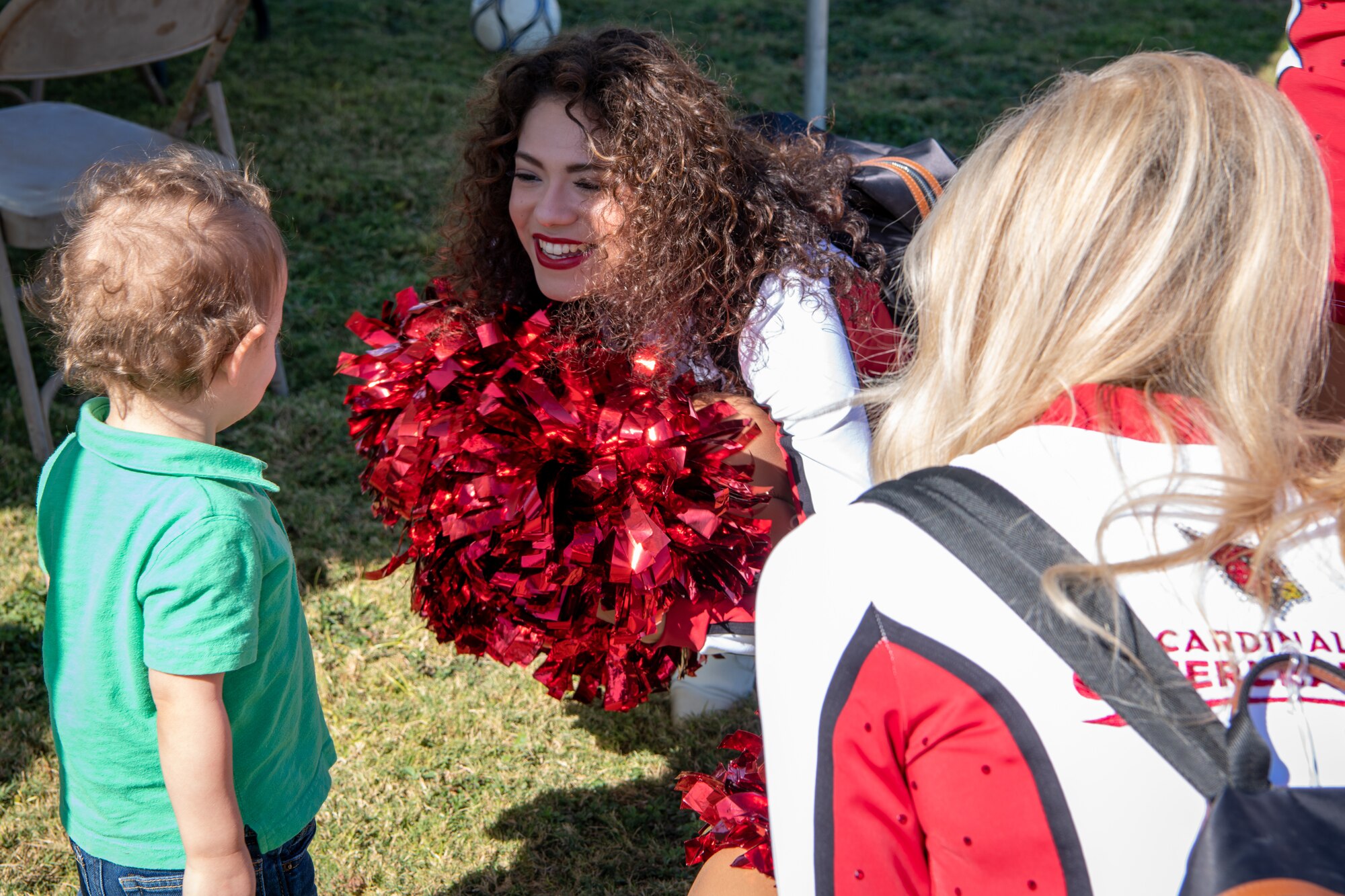 Arizona Cardinals cheerleaders interact with one of our littlest Thunderbolts Nov. 4, 2021, at Luke Air Force Base, Arizona.