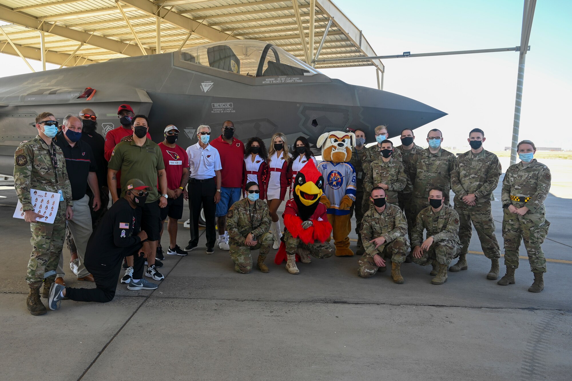 Airmen from the 61st Aircraft Maintenance Unit and guests from the Arizona Cardinals stand next to an F-35A Lightning II Nov. 4, 2021, at Luke Air Force Base, Arizona.
