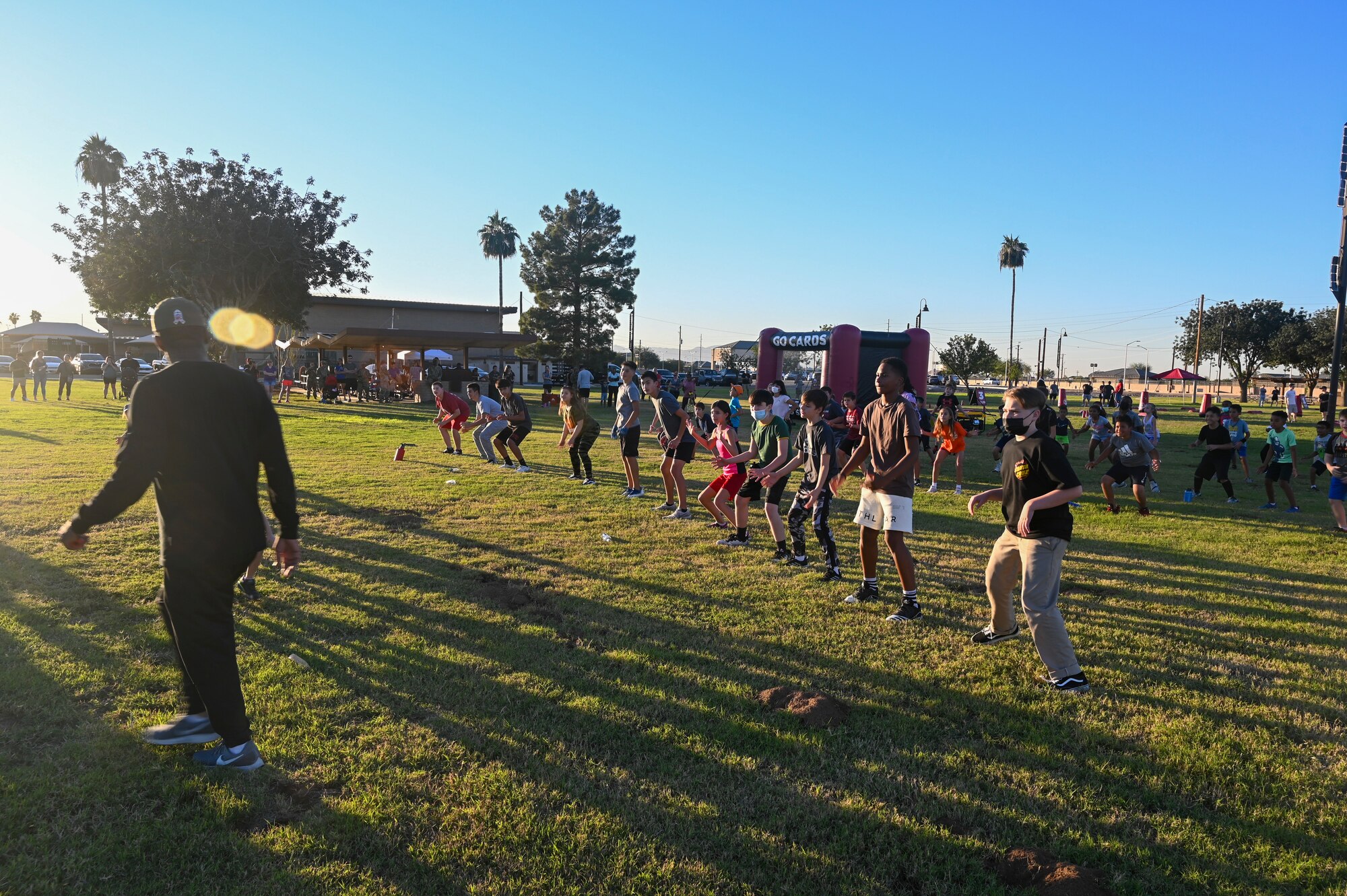 Mo Streety, U.S. Air Force veteran and youth football program manager for the Arizona Cardinals, leads a warm-up during a kids camp at Fowler Park Nov. 4, 2021, at Luke Air Force Base, Arizona.