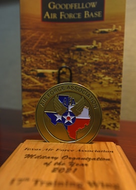 The Texas Air Force Association award and coin display at the Norma Brown building on Goodfellow Air Force Base, Texas, Nov. 9, 2021. Members from the Texas AFA recognized the 17th Training Wing with the award during a wing staff meeting. (U.S. Air Force photo by Senior Airman Ashley Thrash)